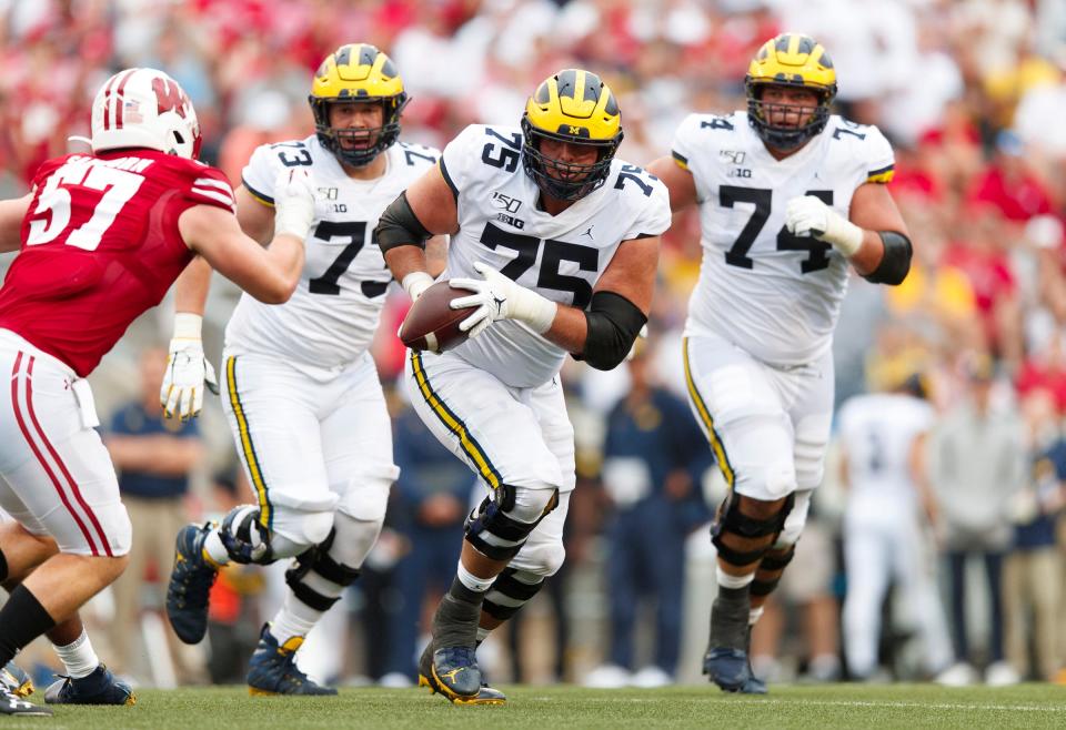 Michigan offensive lineman Jon Runyan Jr. (75) runs with the ball during the fourth quarter against Wisconsin, Saturday, Sept. 21, 2019, in Madison, Wis.