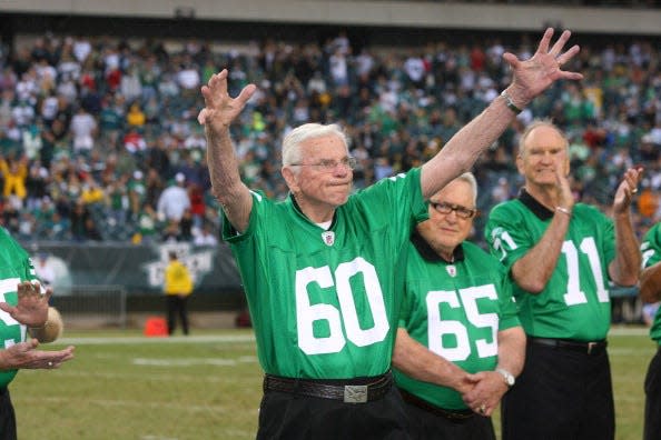 Former Philadelphia Eagles linebacker Chuck Bednarik, No. 60, waves to the crowd at halftime ceremonies during a game against the Green Bay Packers on Sept. 12, 2010, at Lincoln Financial Field. Bednarik and the 1960 Eagles were honored for winning the NFL championship that year.