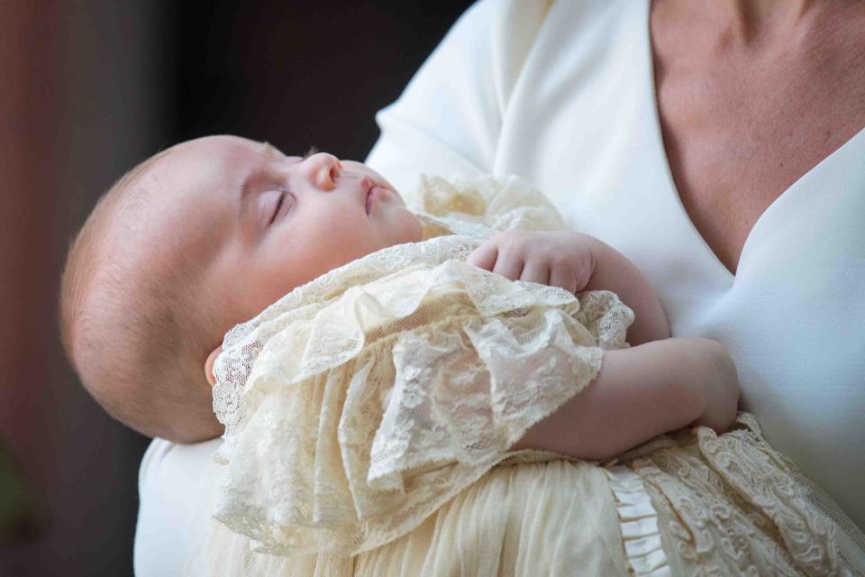 Britain's Prince Louis of Cambridge is carried by Britain's Catherine, Duchess of Cambridge on their arrival for his christening service at the Chapel Royal, St James's Palace, London on July 9, 2018. (Photo by Dominic Lipinski / POOL / AFP)        (Photo credit should read DOMINIC LIPINSKI/AFP/Getty Images)