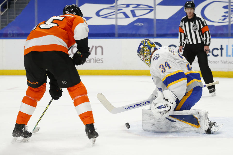 Buffalo Sabres goalie Jonas Johansson (34) stops Philadelphia Flyers forward James Van Riemsdyk (25) during the first period of an NHL hockey game, Sunday, Feb. 28, 2021, in Buffalo, N.Y. (AP Photo/Jeffrey T. Barnes)