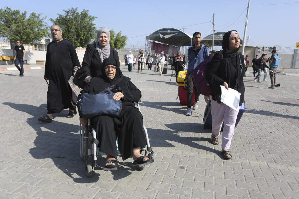 Palestinians cross to the Egyptian side of the border crossing with the Gaza Strip Wednesday, Nov. 1, 2023. in Rafah Wednesday, Nov. 1, 2023. (AP Photo/Hatem Ali)