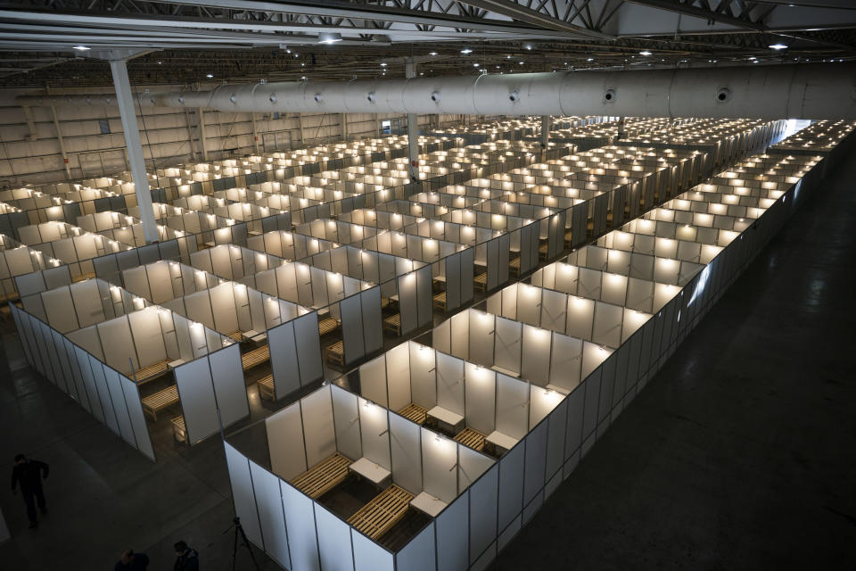 Cots fill Tecnopolis Park in Buenos Aires, Argentina, Friday, April 17, 2020. Authorities set up the field hospital in this space that normally hosts museum exhibits, fairs and other attractions, to take in patients with mild COVID-19 symptoms if necessary. (AP Photo/Victor R. Caivano)