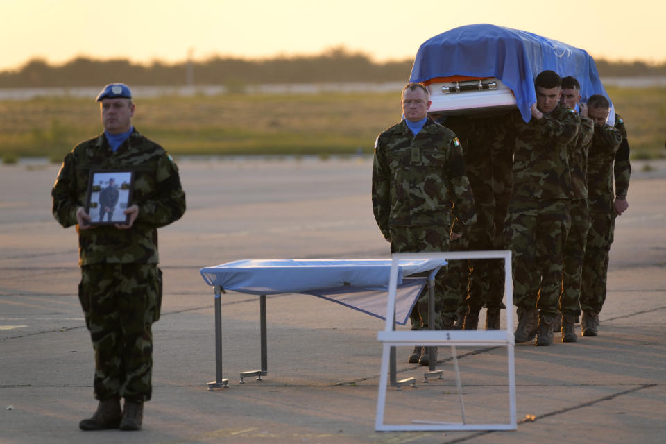 Irish U.N peacekeepers, carry the coffin draped by the United Nations flag of their comrade Pvt. Seán Rooney of Newtowncunningham who was killed during a confrontation with residents near the southern town of Al-Aqbiya on Wednesday night, during his memorial procession at the Lebanese army airbase, at Beirut airport, Sunday, Dec. 18, 2022. (AP Photo/Hussein Malla)