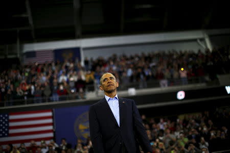 U.S. President Barack Obama stands on stage after delivering remarks at University of Nebraska Omaha arena, in Omaha, Nebraska, January 13, 2016. REUTERS/Carlos Barria