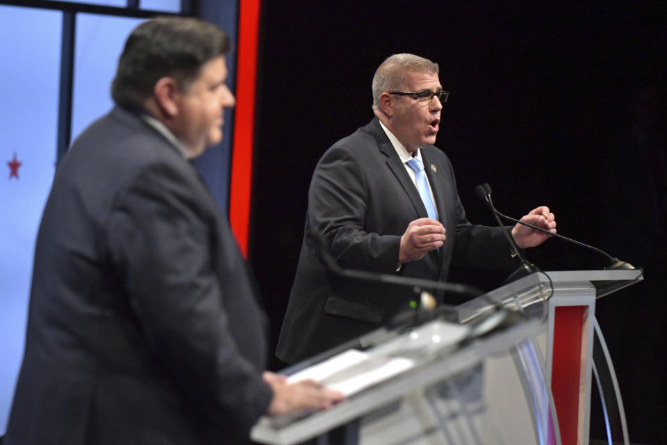 FILE - Illinois state Sen. Darren Bailey, right, the Republican candidate for governor, and incumbent Illinois Gov. JB Pritzker debate during the Illinois Governor's Debate in Normal, Ill., on Oct. 6, 2022. With U.S. union ranks swelling as everyone from coffee shop baristas to warehouse workers seeks to organize, Illinois voters will decide in November 2022 whether to amend their state constitution to guarantee the right to bargain collectively. (Ron Johnson/Illinois State University via AP, Pool, File)