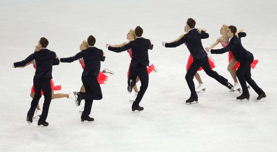 In this multiple exposure photo, Ekaterina Bobrova and Dmitri Soloviev of Russia compete in the team ice dance short dance figure skating competition at the Iceberg Skating Palace during the 2014 Winter Olympics, Saturday, Feb. 8, 2014, in Sochi, Russia. (AP Photo/Bernat Armangue)