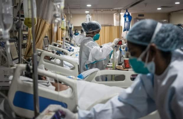 Medical staff attend to COVID-positive patients in the ICU at Holy Family hospital in New Delhi on May 6. 