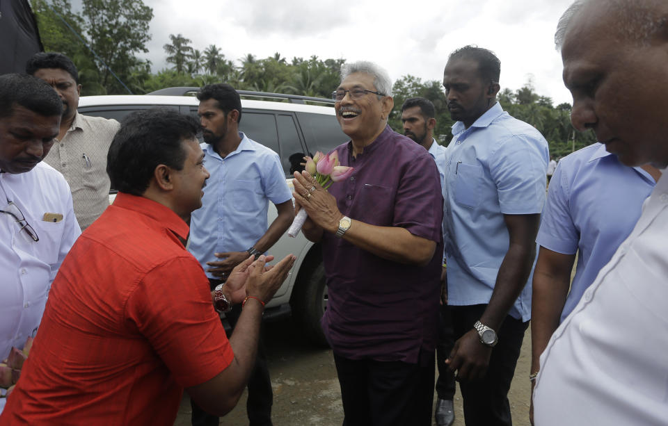 Sri Lankan presidential candidate and former defense chief Gotabaya Rajapaksa is received by supporters in Neluwa village in Galle, Sri Lanka, Tuesday, Oct. 22, 2019. The daughter of a Sri Lankan journalist assassinated during the country's civil war says she'll appeal a U.S. court's decision to throw out her lawsuit against Rajapaksa, the front-runner in Sri Lanka's upcoming presidential election. Rajapaksa was defense chief when Lasantha Wickrematunge, editor of the Sunday Leader newspaper, was killed in January 2009, around four months before the end of the long civil war. (AP Photo/Eranga Jayawardena)
