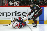 Arizona Coyotes center Carl Soderberg (34) sends Washington Capitals right wing Tom Wilson (43) to the ice during the first period of an NHL hockey game Saturday, Feb. 15, 2020, in Glendale, Ariz. (AP Photo/Ross D. Franklin)