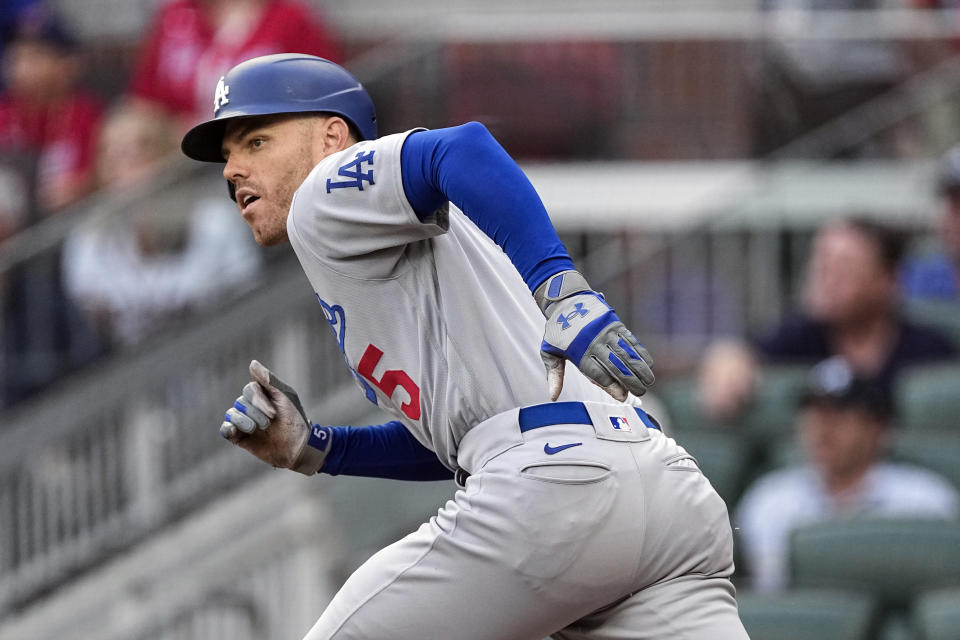 Los Angeles Dodgers first baseman Freddie Freeman runs to first base after hitting a single in the first inning of a baseball game against the Atlanta Braves, Wednesday, May 24, 2023, in Atlanta. (AP Photo/John Bazemore)