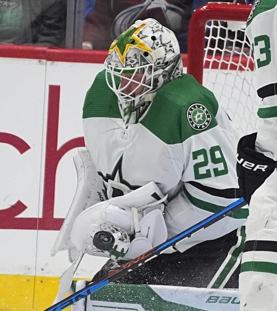 Dallas Stars goaltender Jake Oettinger makes a glove save in the second period of an NHL hockey game against the Colorado Avalanche Sunday, April 7, 2024, in Denver. (AP Photo/David Zalubowski)