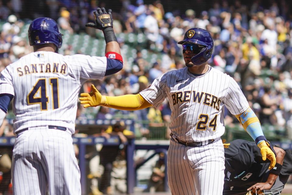 Milwaukee Brewers' William Contreras is congratulated by Carlos Santana after hitting a home run during the first inning of a baseball game against the San Diego Padres Sunday, Aug. 27, 2023, in Milwaukee. (AP Photo/Morry Gash)