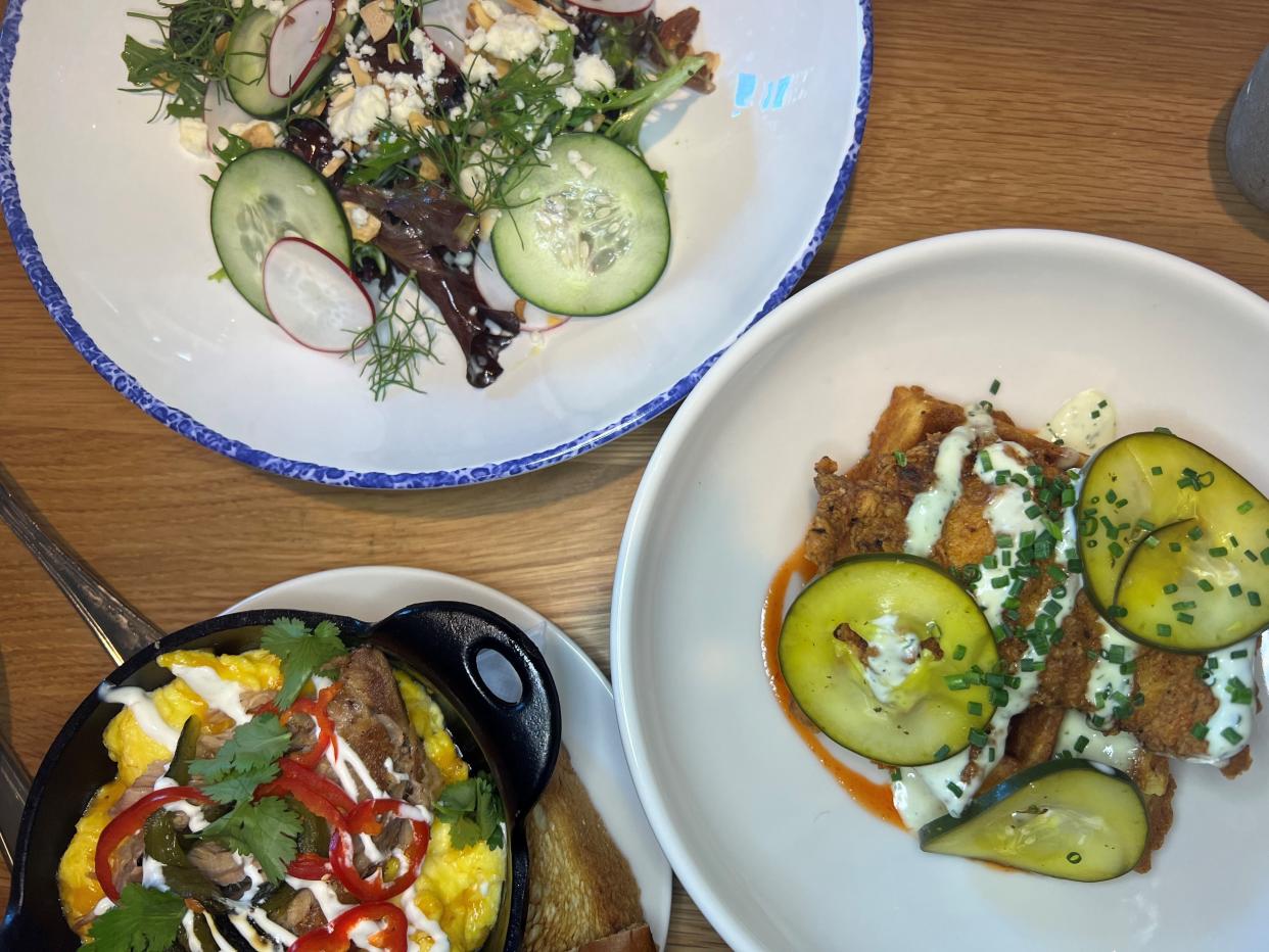 Clockwise from top: a lemon garden party salad, mac and cheese waffles with Asheville hot fried chicken, and pork and poblano pepper scramble at Tupelo Honey, the new Southern restaurant in downtown Des Moines.