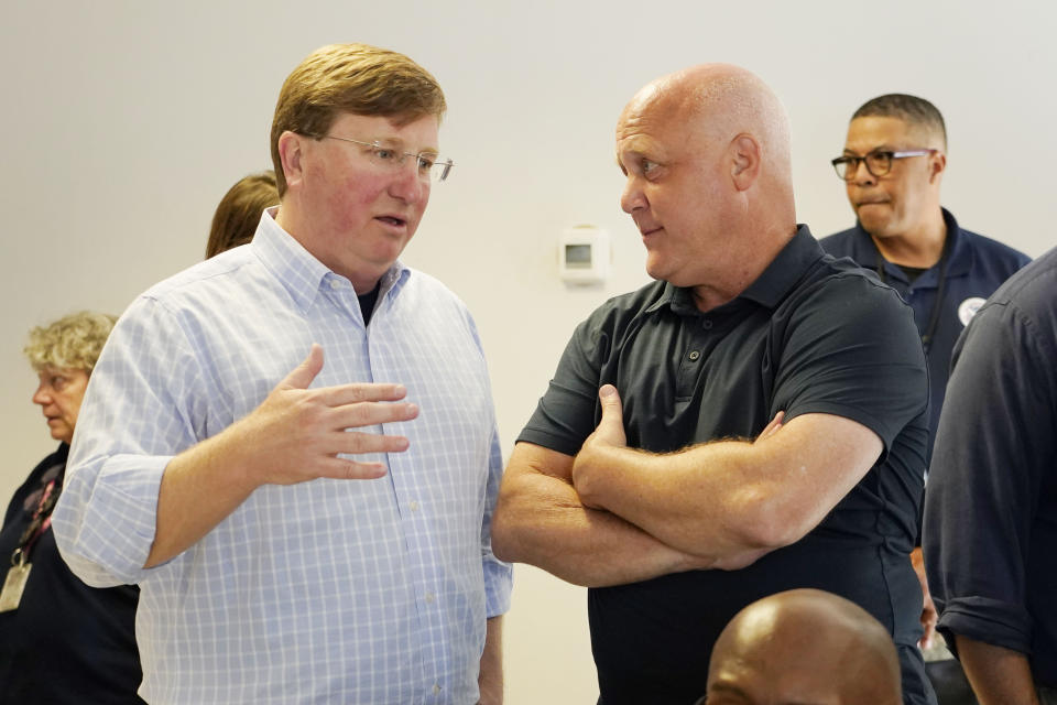 White House Infrastructure Coordinator Mitch Landrieu, right, and Mississippi Gov. Tate Reeves, left, confer during a visit by Deanne Criswell, administrator of the Federal Emergency Management Agency (FEMA), to the City of Jackson's O.B. Curtis Water Treatment Facility in Ridgeland, Miss., Friday, Sept. 2, 2022. Jackson's water system partially failed following flooding and heavy rainfall that exacerbated longstanding problems in one of two water-treatment plants. (AP Photo/Rogelio V. Solis)
