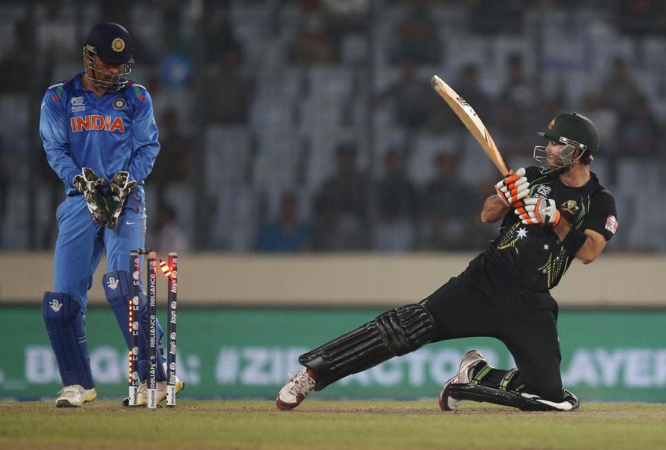 Australia's batsman Glenn Maxwell, right, is bowled out by India's bowler Ravichandran Ashwin during their ICC Twenty20 Cricket World Cup match in Dhaka, Bangladesh, Sunday, March 30, 2014. (AP Photo/Aijaz Rahi)