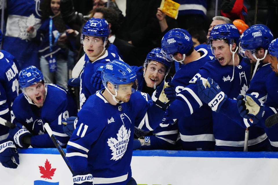 Toronto Maple Leafs' Max Domi (11) celebrates his goal with the team bench during a shootout in an NHL hockey game against the New York Rangers in Toronto on Saturday, March 2, 2024. (Frank Gunn/The Canadian Press via AP)