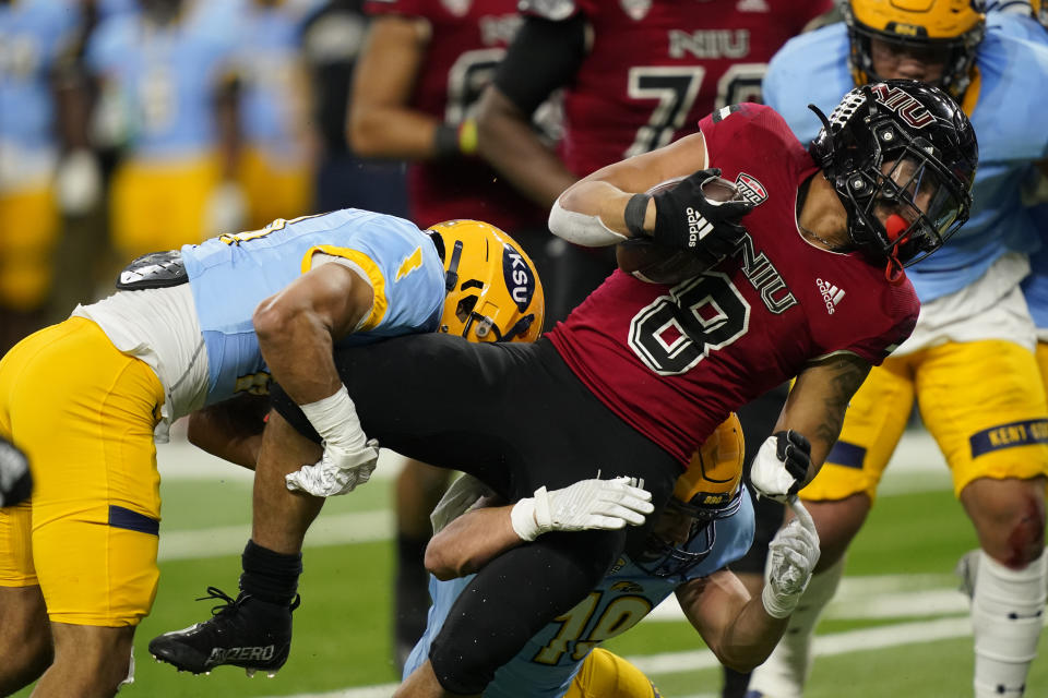 Kent State cornerback Elvis Hines, left, stops Northern Illinois running back Jay Ducker (8) during the first half of an NCAA college football game, Saturday, Dec. 4, 2021, in Detroit. (AP Photo/Carlos Osorio)