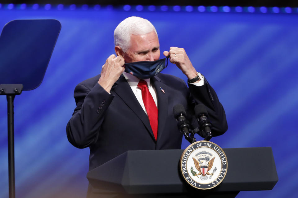 Vice President Mike Pence removes his mask to make comments at First Baptist Church Dallas during a Celebrate Freedom Rally in Dallas, Sunday, June 28, 2020. (AP Photo/Tony Gutierrez)