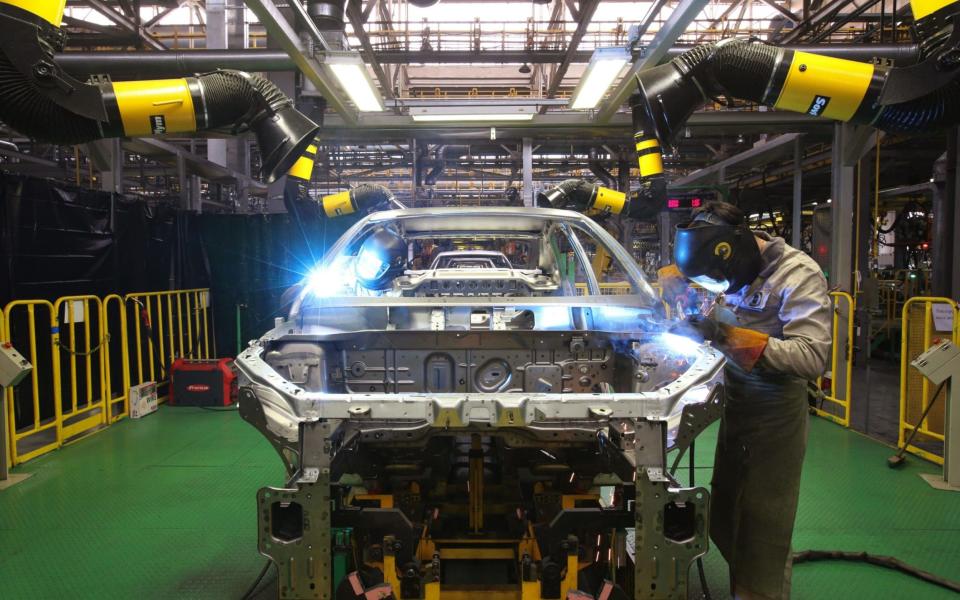 Workers weld panels on the body shell of a Lada Vesta automobile on the assembly line at the Izhevsk Automobile Plant - Bloomberg