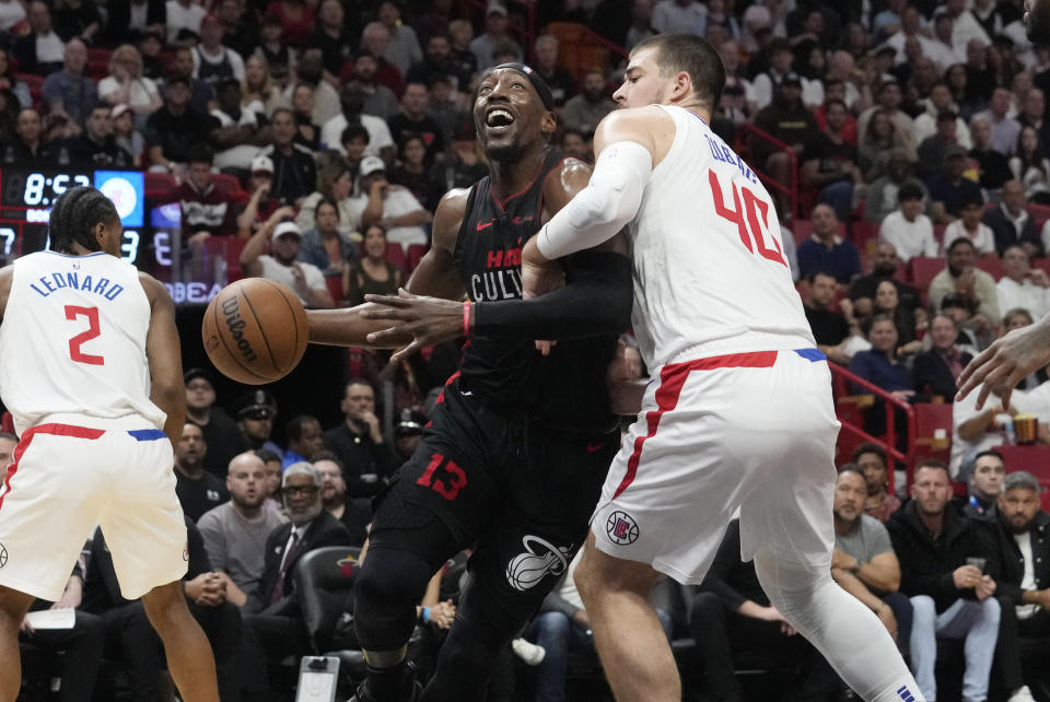 LA Clippers center Ivica Zubac (40) defends Miami Heat center Bam Adebayo (13) during the first half of an NBA basketball game, Sunday, Feb. 4, 2024, in Miami. (AP Photo/Marta Lavandier)