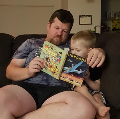 James and his son reading a book together. Source: Facebook