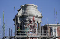 Workers install scaffolding as they prepare to remove the pedestal that once held the statue of Confederate General Robert E. Lee on Monument Avenue Monday Dec 6, 2021, in Richmond, Va. Virginia Gov. Ralph Northam ordered the pedestal removed and the land granted to the City of Richmond. (AP Photo/Steve Helber)