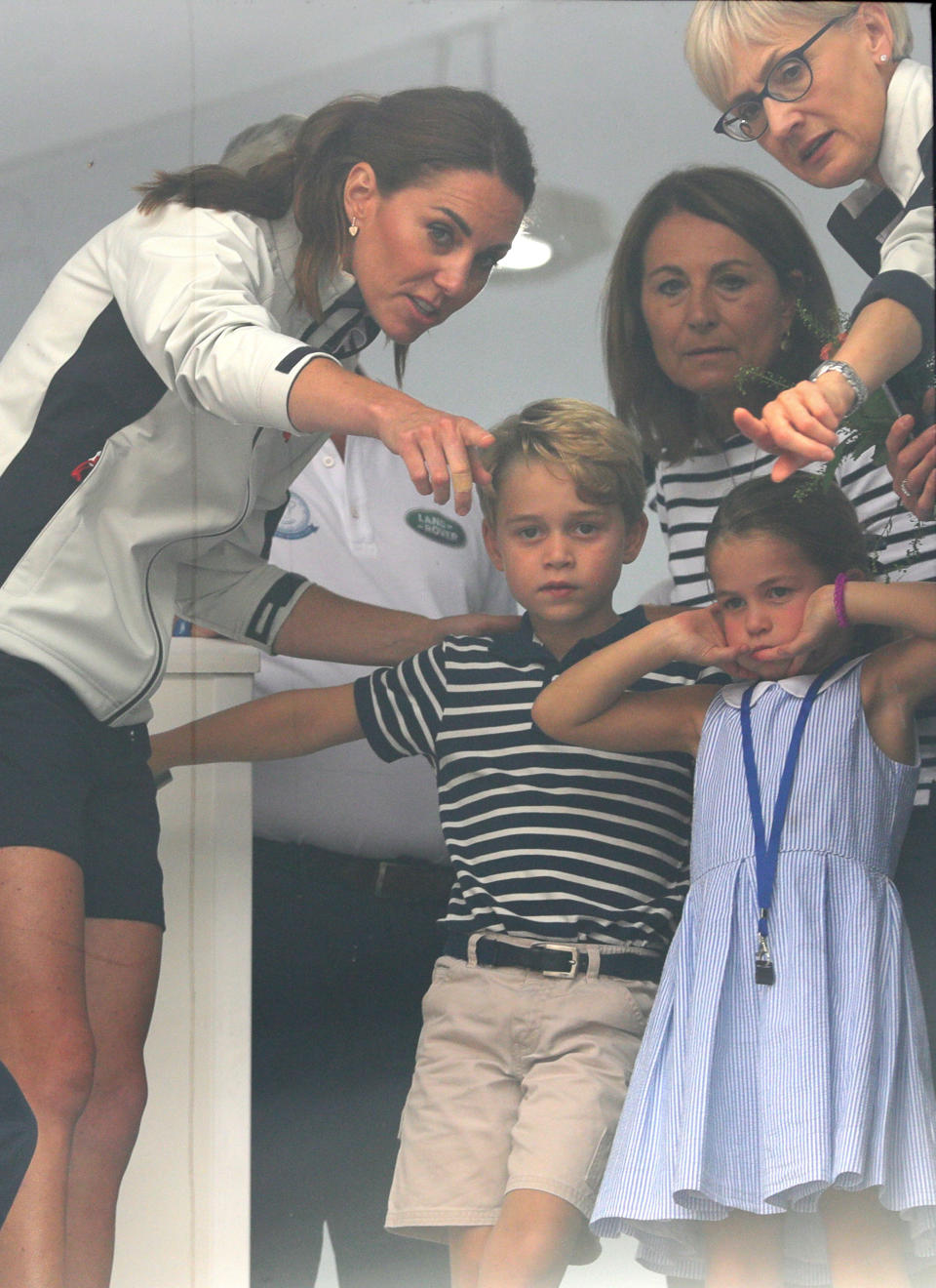 The Duchess of Cambridge with Prince George and Princess Charlotte look through a window at the prize giving after the King's Cup regatta at Cowes on the Isle of Wight. (Photo by Aaron Chown/PA Images via Getty Images)
