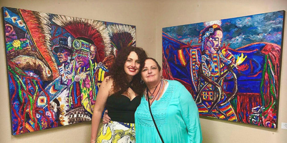 The author (left) and her mother, Meridy Volz, standing with two oil paintings by Meridy Volz in Palm Springs, California, in 2017. (Photo: Courtesy of Novem Cabios)