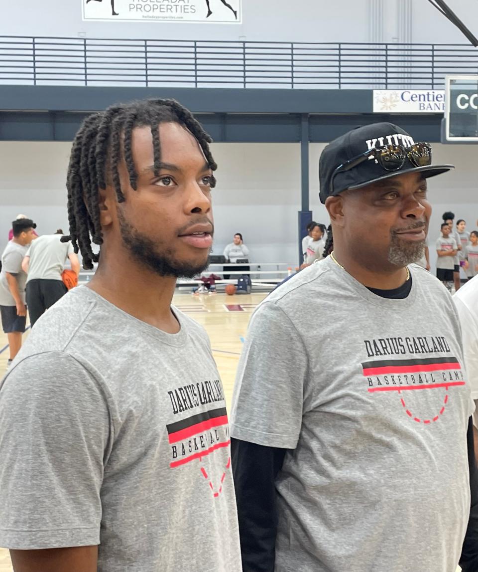 Cavaliers All-Star point guard Darius Garland and his father, Winston Garland, watch a drill during his youth basketball camp June 10 in Merrillville, Indiana.