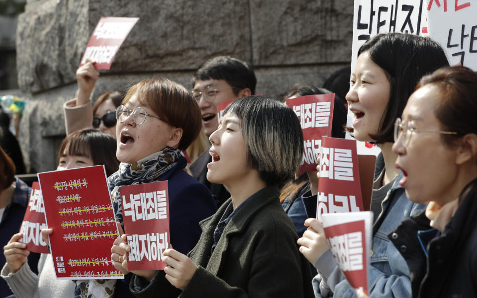 Protesters celebrate after listening to a judgment during a rally demanding the abolition of abortion law outside of the Constitutional Court in Seoul, South Korea, Thursday, April 11, 2019. South Korea's Constitutional Court has ruled that the country's decades-long ban on abortions is incompatible with the constitution, setting up a likely easing of restrictions. (AP Photo/Lee Jin-man)