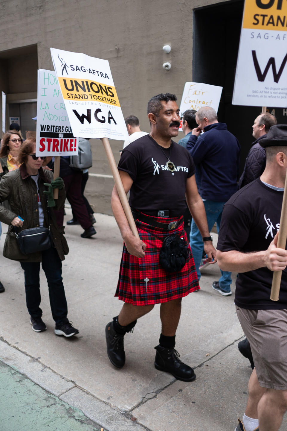 Man at the WGA protest wearing a kilt and boots