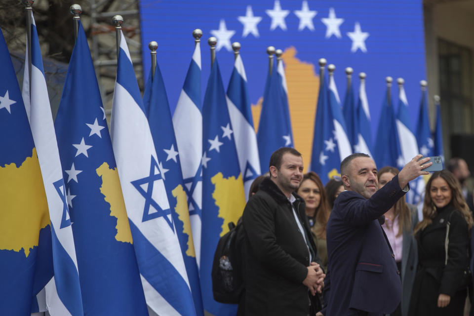 A government official takes a selfie during a signing ceremony held digitally, in the capital Pristina, Monday, Feb. 1, 2021. Kosovo and Israel formally have established diplomatic ties in a ceremony held digitally due to the pandemic lockdown. Kosovo’s Foreign Minister Meliza Haradinaj-Stublla and her Israeli counterpart Gabriel Ashkenazi on Monday held a virtual ceremony signing the documents. The two countries considered it as “making history” and marking “a new chapter.” (AP Photo/Visar Kryeziu)