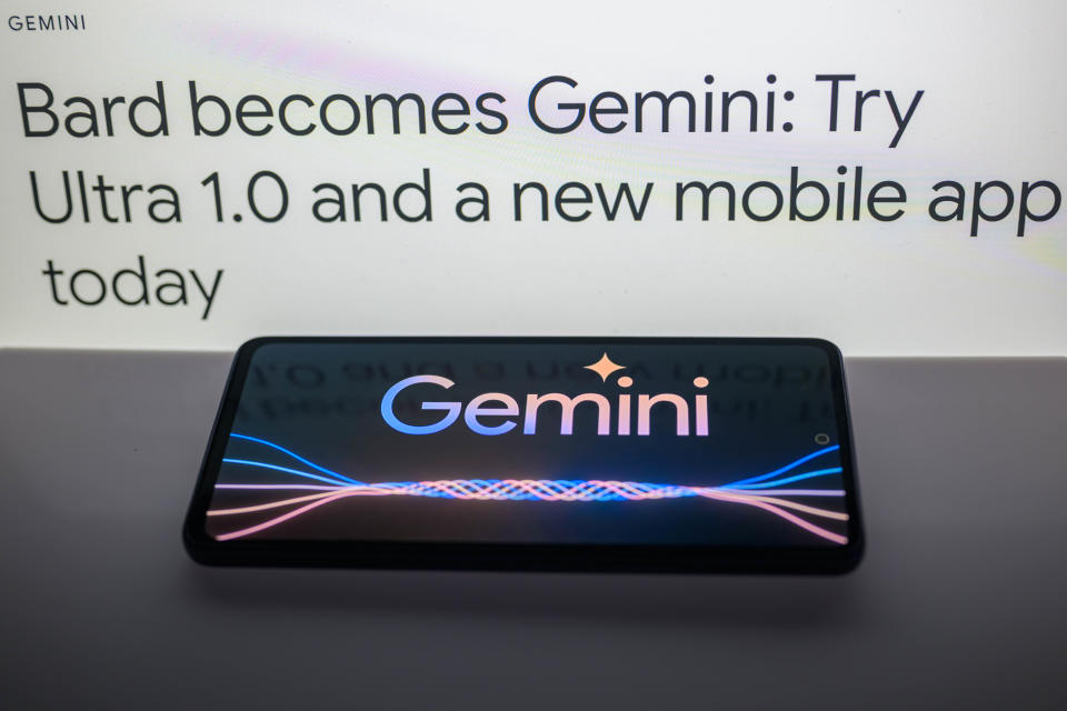 This photo illustration taken in Brussels, Belgium on February 8, 2024 shows the Gemini logo on a smartphone with a DeepMind web blog post in the background.  (Photo by Jonathan Raa/NurPhoto via Getty Images)