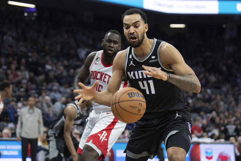 Sacramento Kings forward Trey Lyles (41) rebounds the ball in front of Houston Rockets forward Usman Garuba (16) during the first half of an NBA basketball game in Sacramento, Calif., Friday, Jan. 13, 2023. (AP Photo/José Luis Villegas)