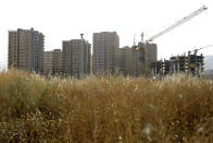 This July 6, 2019 photo shows residential towers in District 22, that consists of apartment high-rises and shopping malls arranged around an artificial lake called Chitgar, under construction on the northwestern edge of Tehran, Iran. Iran’s large middle class has been hit hard by the fallout from unprecedented U.S. sanctions, including the collapse of the national currency. Perhaps most devastating has been the doubling of housing prices. The spike has uprooted tenants and made home ownership unattainable for most. (AP Photo/Ebrahim Noroozi)