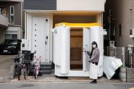 Megumi Morohoshi, a Japanese mother of three, poses for a photo outside her family's newly installed bomb shelter in Saitama