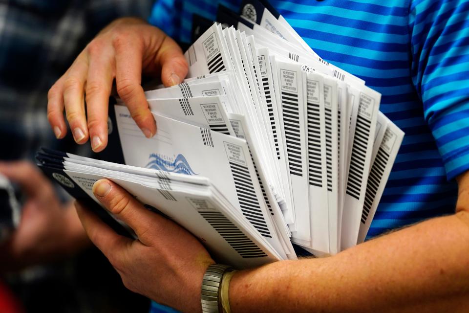 Kyle Hallman, with Chester County Voter Services, organizes mail-in ballots to be sorted for the 2020 General Election Oct. 23, 2020, in West Chester, Pa. In Mississippi, voters head to the polls Tuesday to vote in four primary elections.