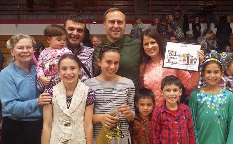 Adam Cote and Ogy Nikolic and their families attend a fundraiser in Sanford, Maine, in 2016. Front: Cote's children, Audrey, left, Ana, Mikey, AJ, and Mia. Back: Cote's mother, Kitty Chadbourne, left, Ogy and his daughter, Anastasija, Cote, and Nikolic's wife, Sanja.