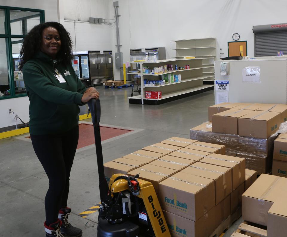 Denise Hurtado-Valdez, a home delivery coordinator with the Food Bank of Delaware, prepares to move a pallet of food for local drivers from Amazon Flex and DoorDash.