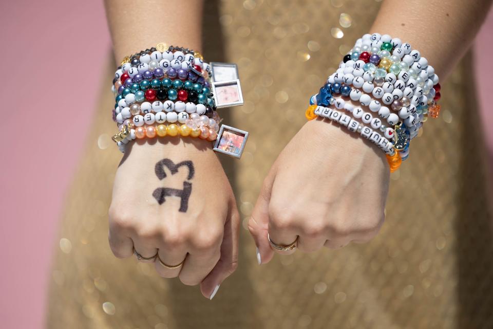 Swiftie Kelly Griffiths, 18, shows off her friendship bracelets and 13 on her hand, a nod to Taylor Swift's favorite number, outside an Inglewood, California, stadium before Swift's performance there this month.