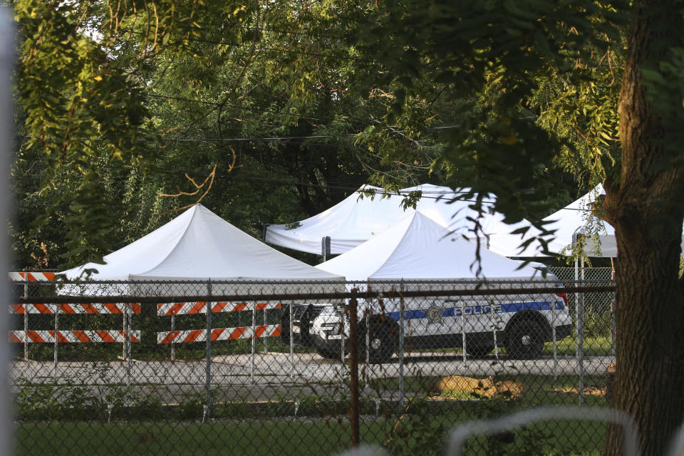 A police car and tents sit in the backyard of a home following a report that two bodies may be buried there in suburban Lyons, Ill., Friday, Aug. 27, 2021. Authorities are planning to excavate the suburban Chicago backyard Friday after two adult brothers found living in what police called a “hoarder home" said they had buried the bodies of their mother and sister there. (Antonio Perez/Chicago Tribune via AP)