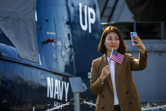 Sora Jung takes a selfie after getting citizenship certificate at a ceremony held by U.S. Citizenship and Immigration Services on Tuesday, Nov. 9, 2021 in San Pedro, CA. (Irfan Khan / Los Angeles Times via Getty Images)