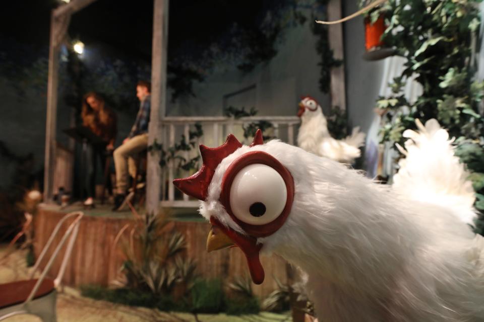 A pair of animatronic chickens named Park and Frenchie bob up and down as Courtney and Eric Schutt rehearse for a show at OFC's The Old Farm Cafe & Dining Experience in Winton Place in Brighton in October 2022.