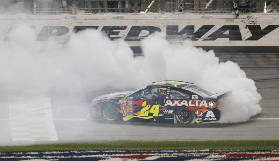 NASCAR driver Jeff Gordon (24) celebrates after winning the Sprint Cup Series auto race at Kansas Speedway in Kansas City, Kan., Saturday, May 10, 2014. (AP Photo/Orlin Wagner)