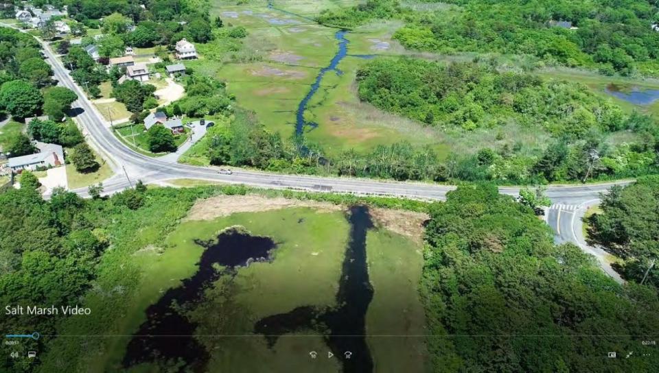 View looking north over Lower County Road and its intersection with South Main Street, at left, of the Weir Creek salt marsh in West Dennis.