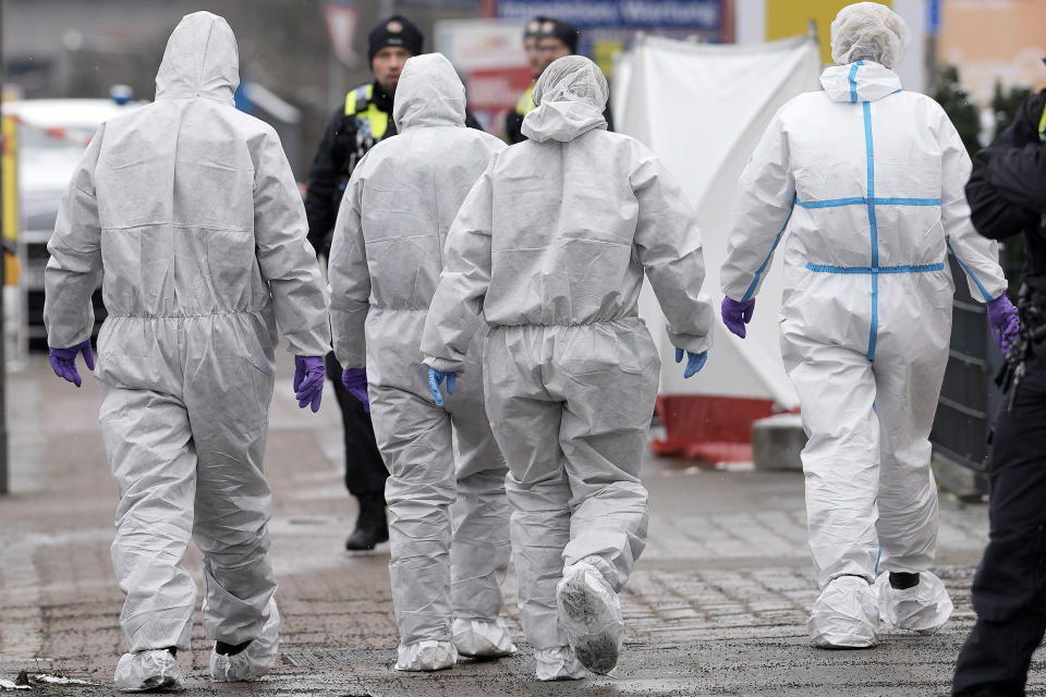 Forensic experts walk to a Jehovah's Witness building in Hamburg, Germany Friday, March 10, 2023. Shots were fired inside the building used by Jehovah's Witnesses in the northern German city of Hamburg on Thursday evening, with multiple people killed and wounded, police said. (AP Photo/Markus Schreiber)