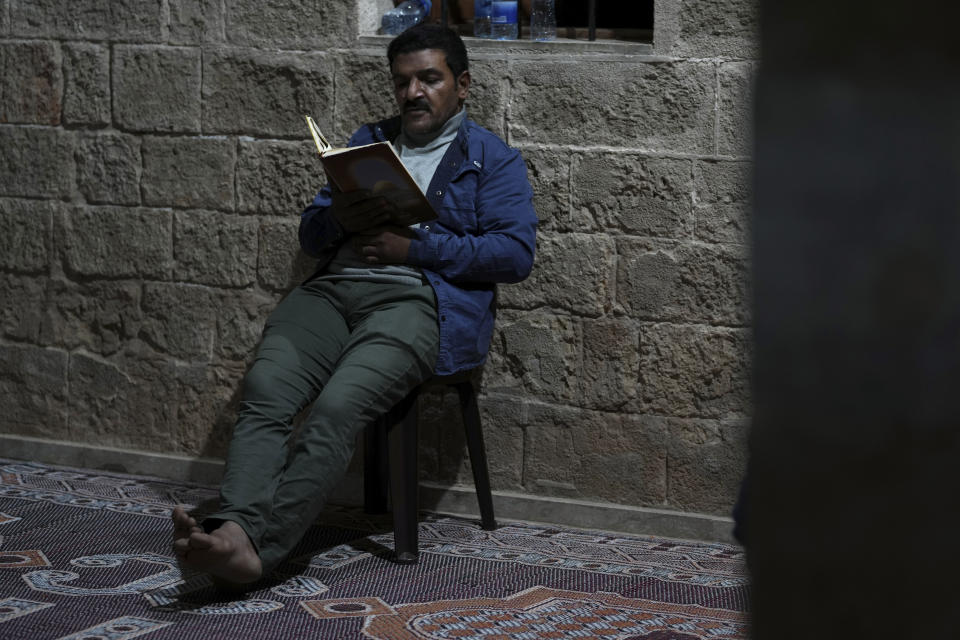 A Palestinian Muslim worshipper recites verses from the Quran, Islam's holy book, during Laylat al-Qadr, also known as the Night of Destiny, at al Sayed Hashim mosque in Gaza City, early Tuesday, April 18, 2023. Laylat al-Qadr is marked on the 27th day of the holy fasting month of Ramadan and is commemorated as the night Prophet Muhammad received the first revelation of the Quran. Muslims traditionally spend the night in prayer and devotion. (AP Photo/Adel Hana)