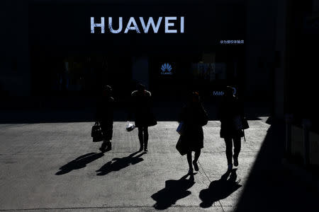 People walk past a Huawei shop in Beijing, China, December 11, 2018. REUTERS/Thomas Peter
