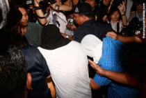 The two men (hooded) convicted in the murder trial of Altantuya Shaariibuu mobbed by the media during a court appearance in 2009. – The Malaysian Insider file pic, February 18, 2015.