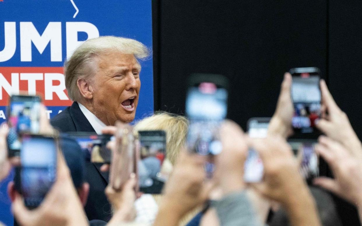 Former US President and 2024 Presidential hopeful Donald Trump arrives to a Team Trump Volunteer Leadership Training at the Grimes Community Center in Grimes, Iowa - Andrew Caballero-Reynolds/AFP via Getty Images